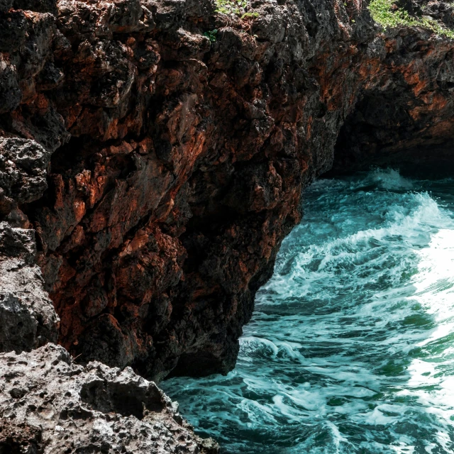 a rocky cliff with a body of water