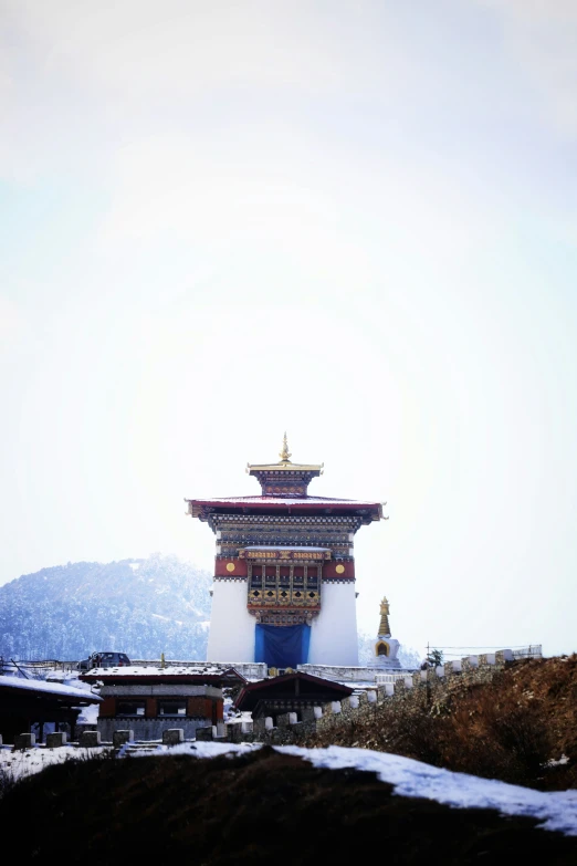 a tall structure sitting next to a pile of dirt