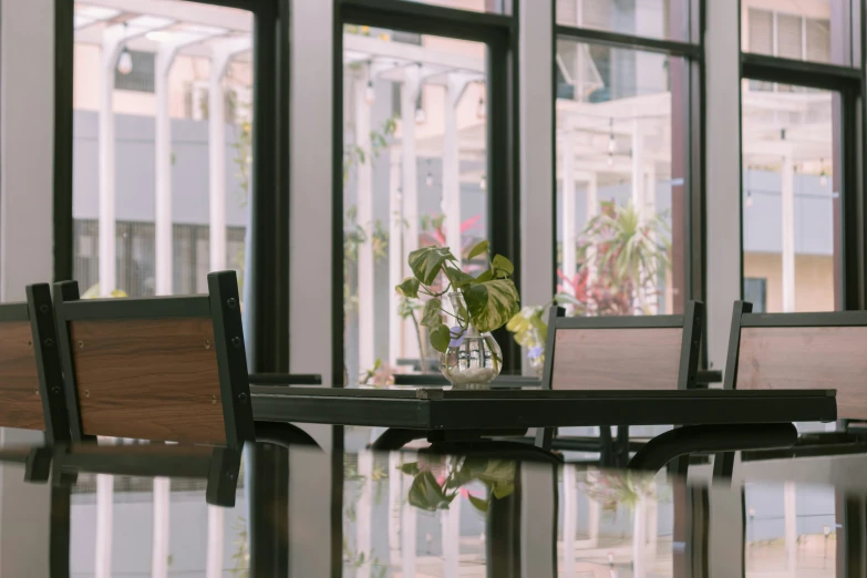 there are two tables in the room with glass doors