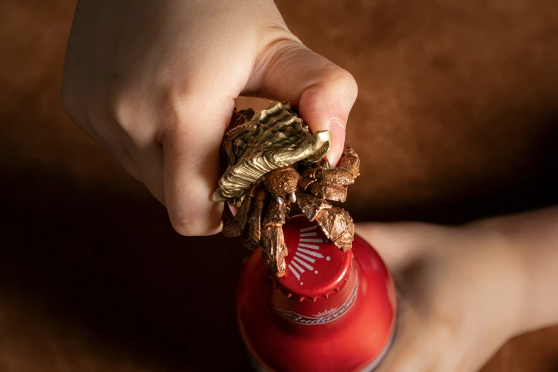 a person holding up a bottle containing a pile of gold dollar bills