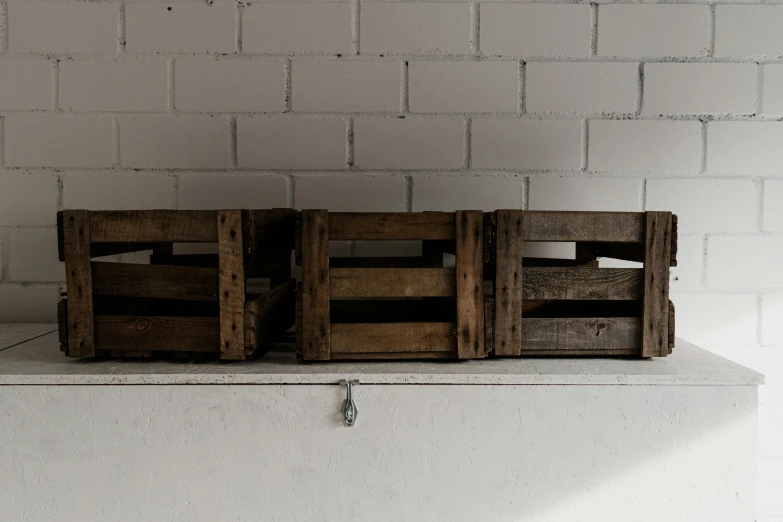 there are wooden crates sitting on the shelf