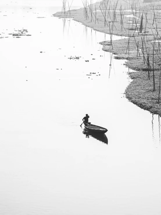 a man floating in a boat on top of water