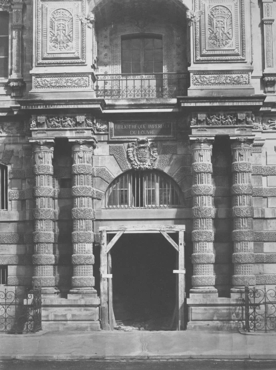 old building with a doorway and a clock on top