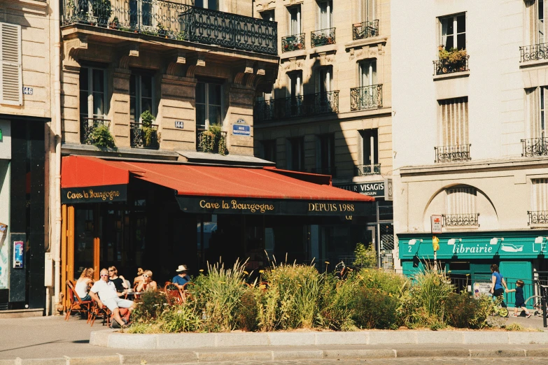 some people sitting at an outdoor table eating