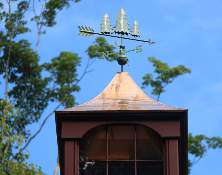 the roof on a building with two weather vane