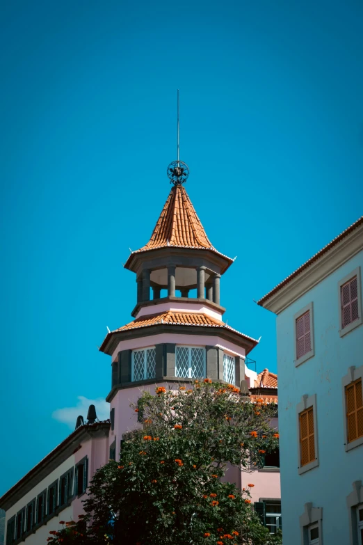 the clock tower on top of a building near many buildings