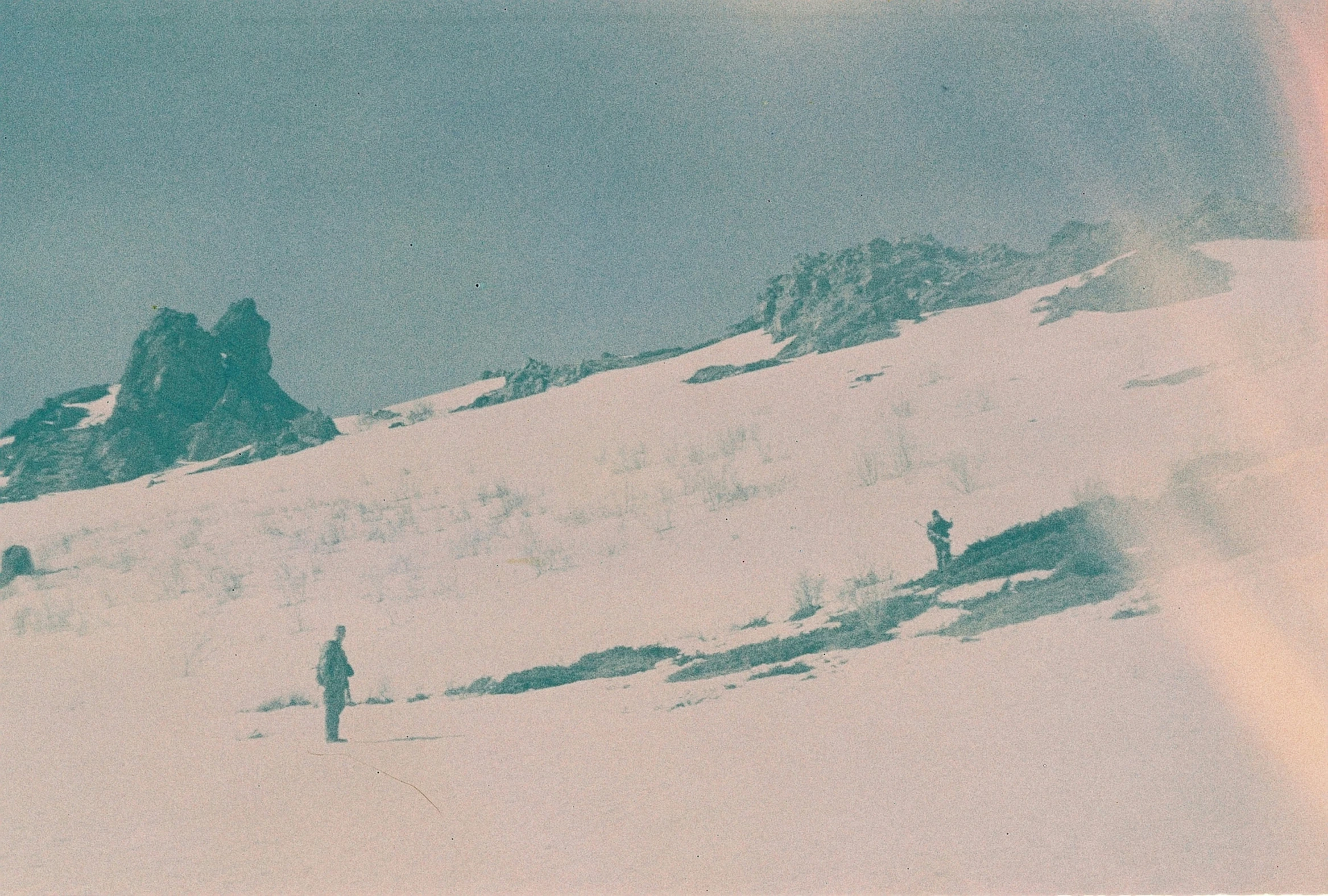 snow covered mountain with a man standing at the top