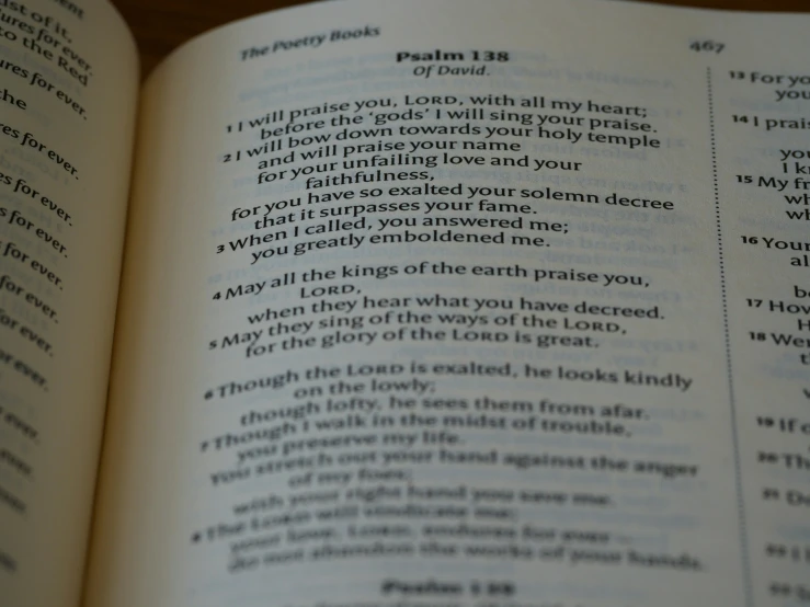 an open bible that has many lines of poetry in the page