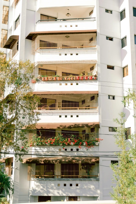 an apartment building with balconies and plants on each balconies