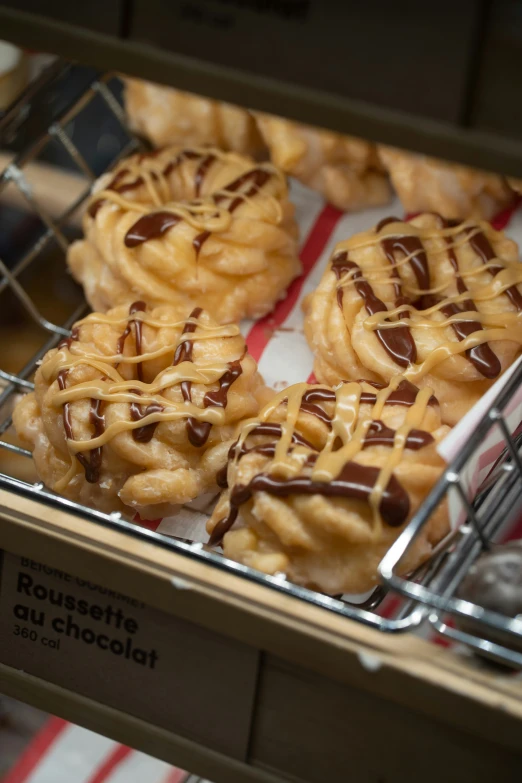 a tray filled with lots of donuts covered in chocolate