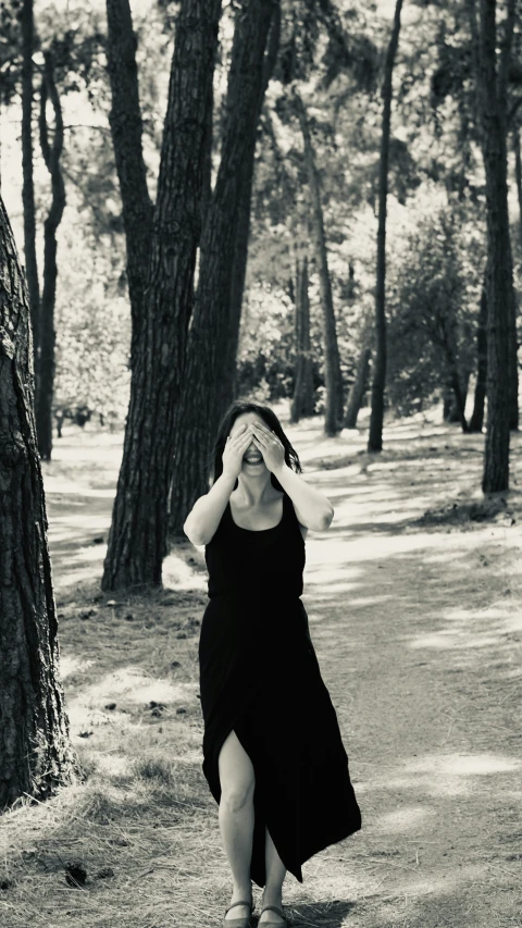 a woman in black dress walking down the street