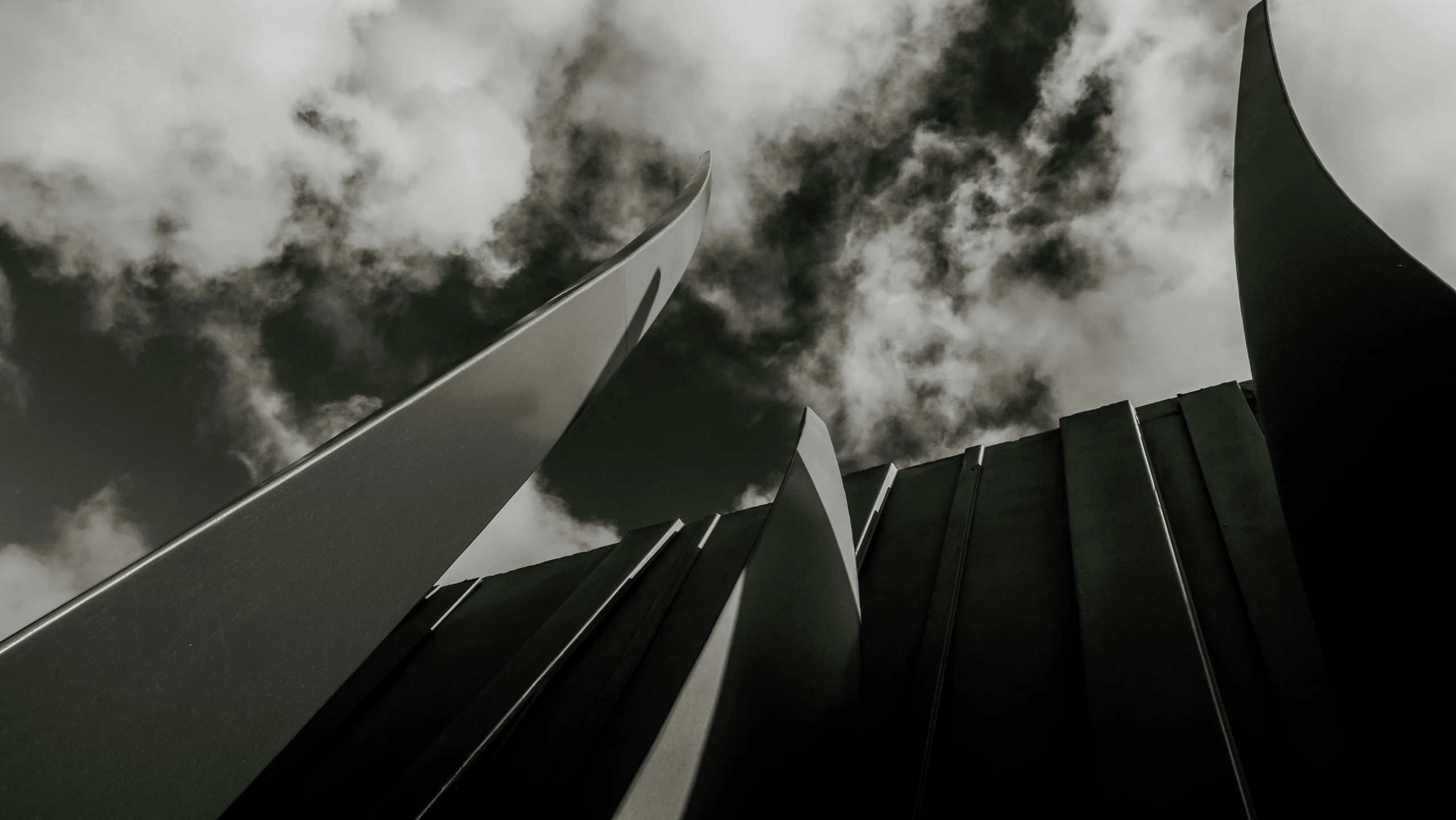 a building is on the ground with clouds overhead