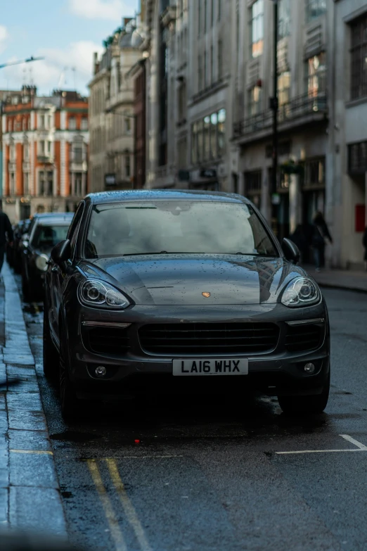 cars parked along the curb of a street in a city