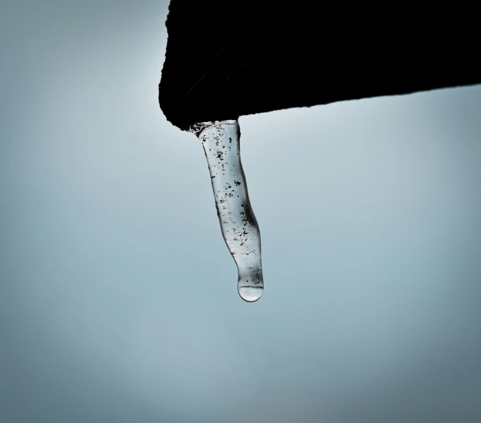 water drops hanging from an umbrella, revealing a small 