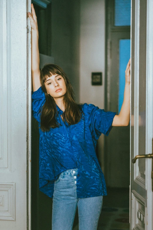 a woman standing in an open doorway of a building