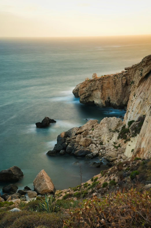 an ocean with some large rocks and water