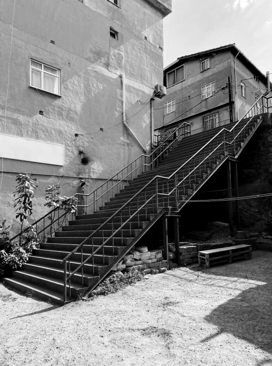 a stair railing sits in front of a building and another building