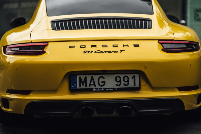 the rear end of a yellow sports car