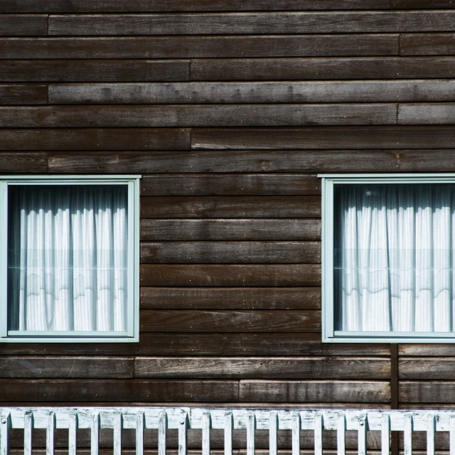 the wall of a building has white windows