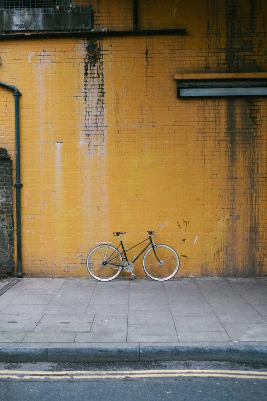 a bike that is leaning against the side of a building