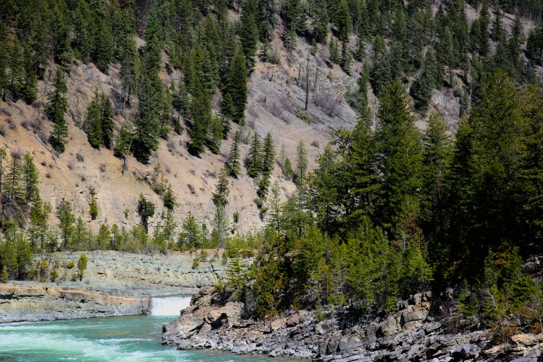 there is a river flowing through the mountain side