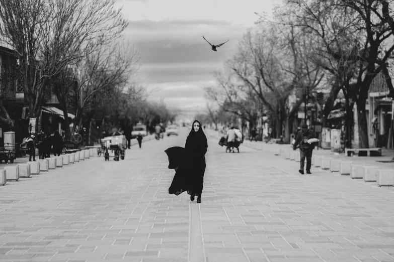 woman walking down a city street with her umbrella open