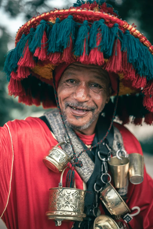 a man with lots of bells around his neck and two hands