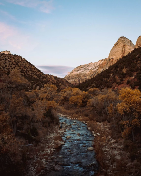 an old - fashioned river runs through a landscape of a rocky area