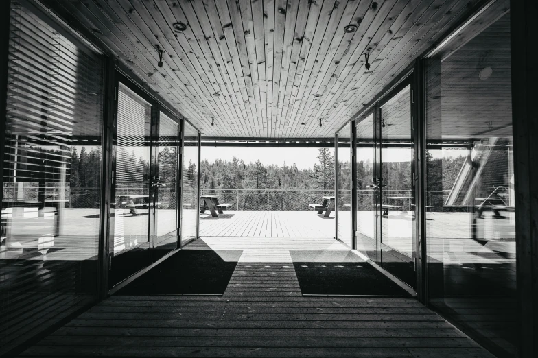 a large open room with glass doors and benches