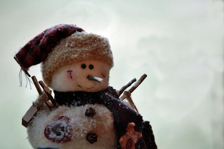 a snowman with a cigarette sticking out of it's mouth