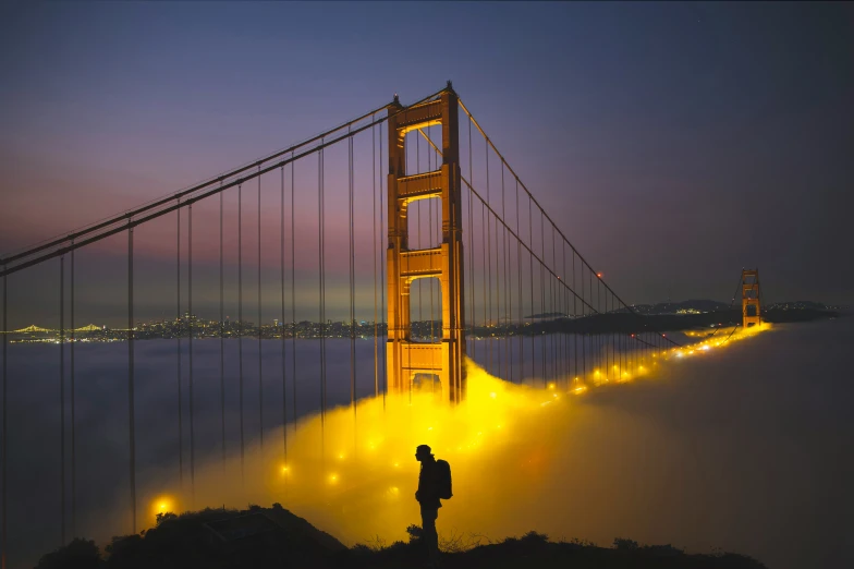 the golden gate bridge at night illuminated by lights