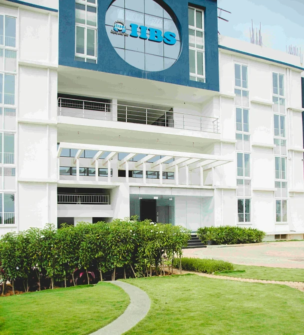 large blue and white building with grass in front