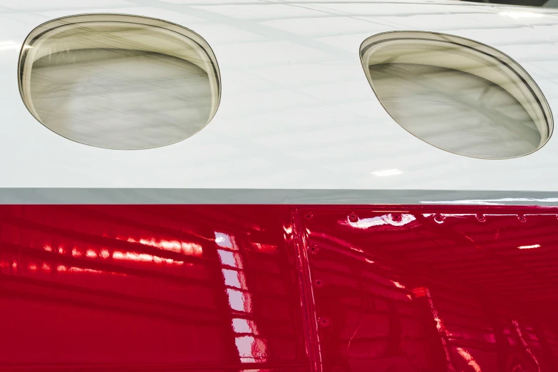 a white and red plane with two round windows