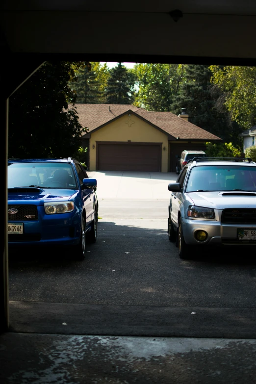 two parked vehicles in front of a house