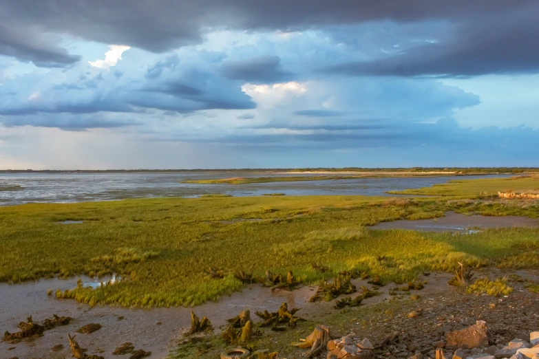 a scenic view of an empty bay and a stormy sky