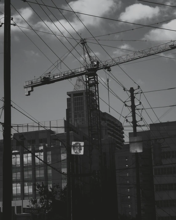 two large building with crane cranes and a few wires