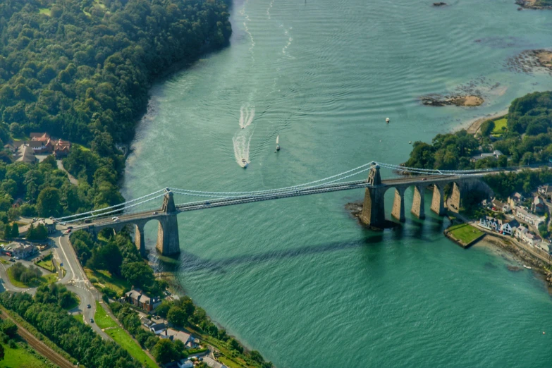 the large bridge is over the water next to houses