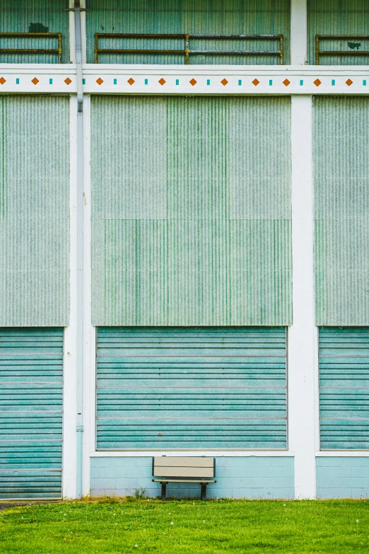 this is a bench and wall in front of a building