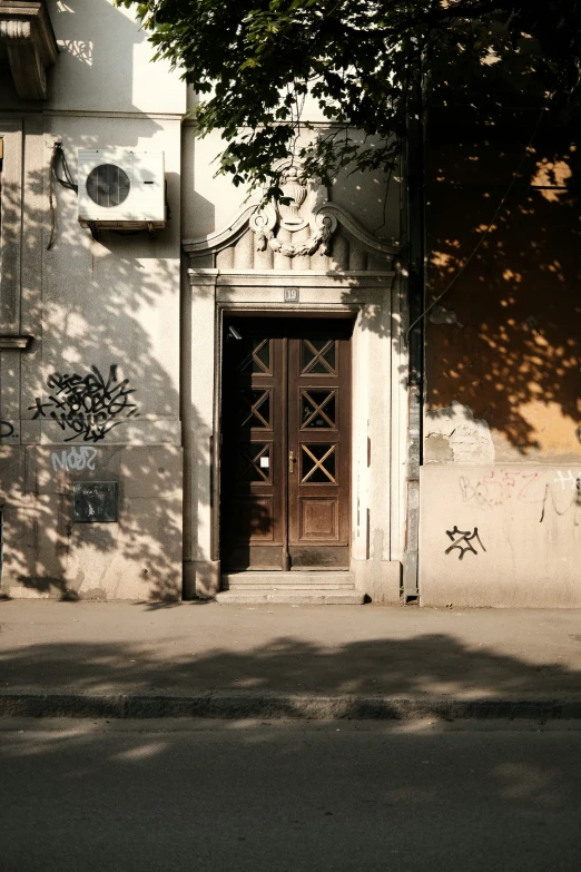 an entrance to the old building is visible from the shadows