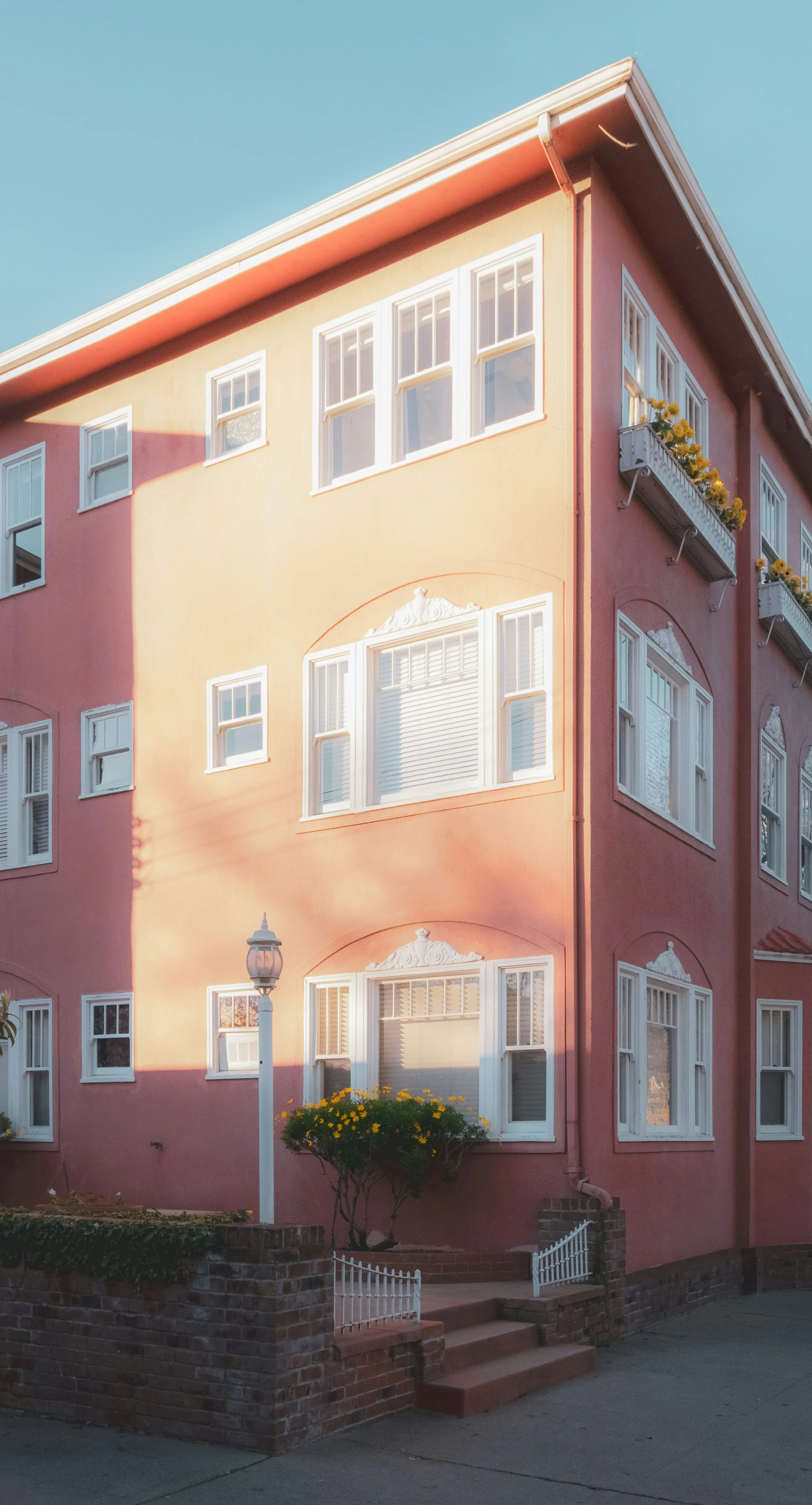 a large orange building with multiple windows and balcony