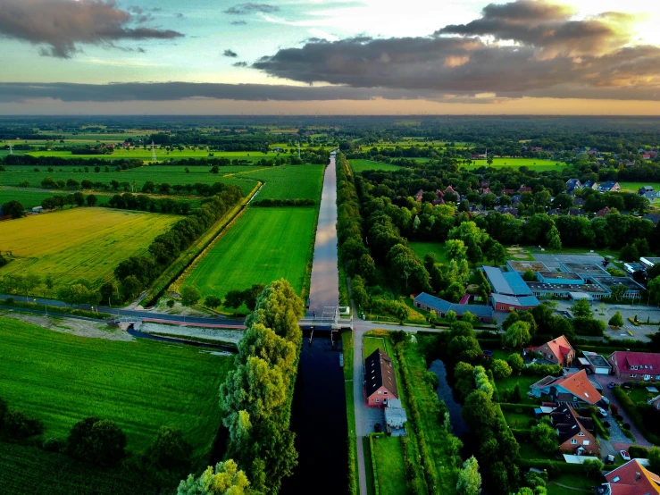 an aerial view of a highway, with fields and houses