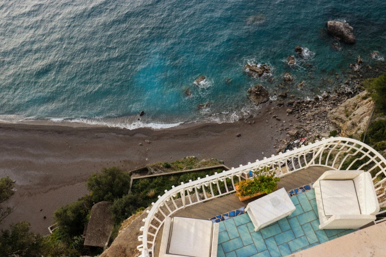 a beautiful pool on the side of the ocean