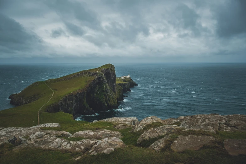 a cliff face and the ocean on an overcast day