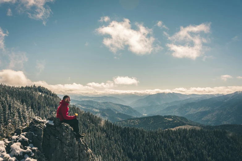 the person is standing on the edge of a cliff