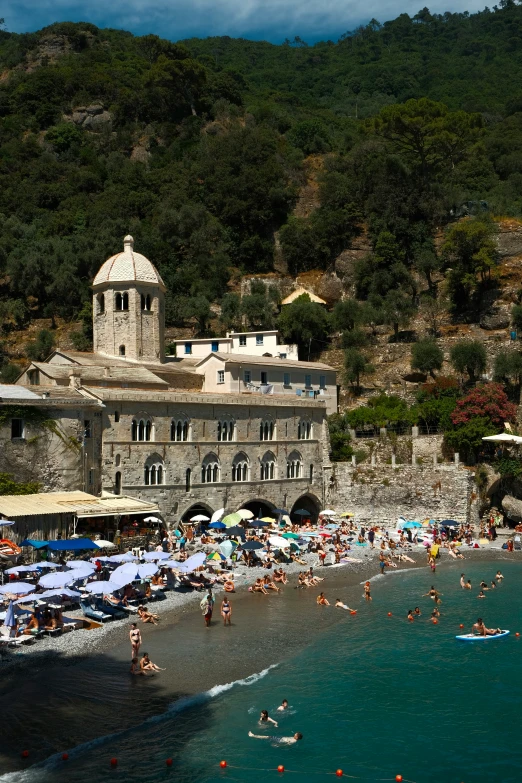 a big building on the shore of a blue body of water