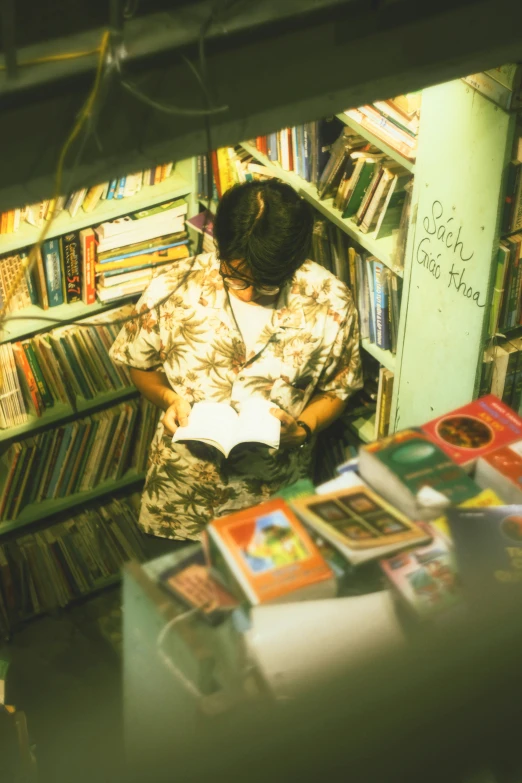 a person reading in a liry filled with books