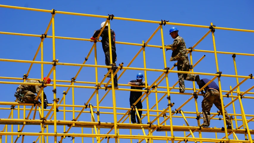 soldiers in protective gear working on scaffolding