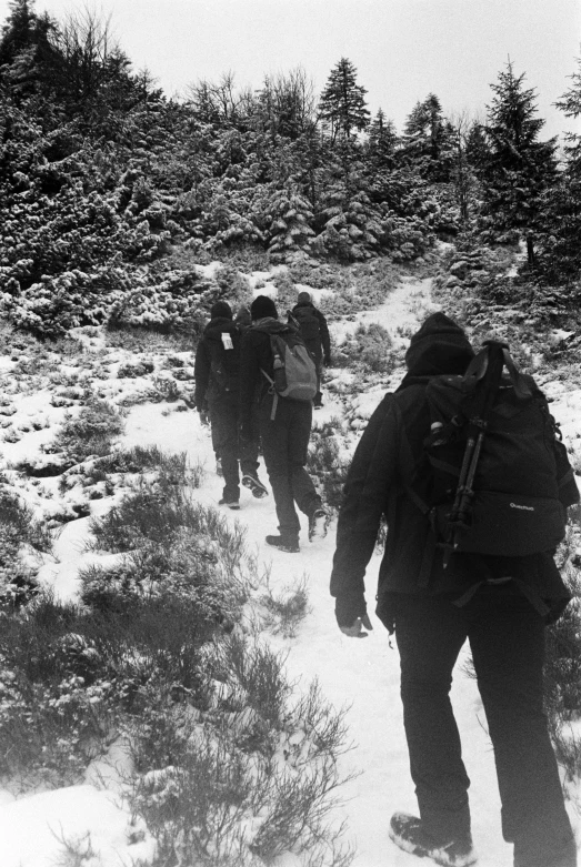 a group of people with backpacks on the side of a mountain