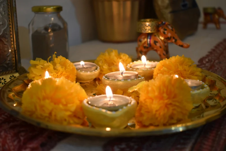 a ss platter filled with small yellow flowers