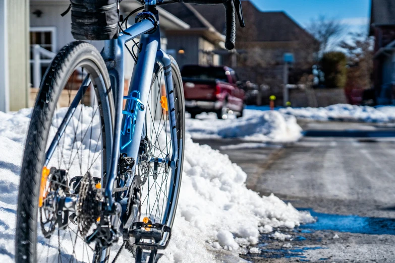 a bike is leaning against the snow in the neighborhood